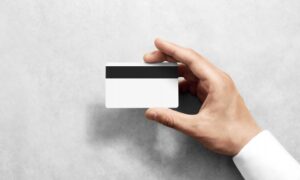 hand-holding-blank-white-credit-card-mockup-black-magnetic-stripe_87790-734